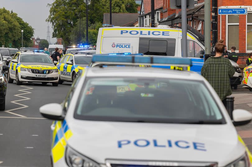 Police at the junction of Washday road and Urban road in Sale