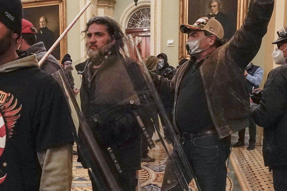 FILE: In this Jan. 6, 2021, photo, rioters, including Dominic Pezzola, center with police shield, are confronted by U.S. Capitol Police officers outside the Senate Chamber inside the Capitol, Wednesday, Jan. 6, 2021, in Washington.  / Credit: Manuel Balce Ceneta / AP