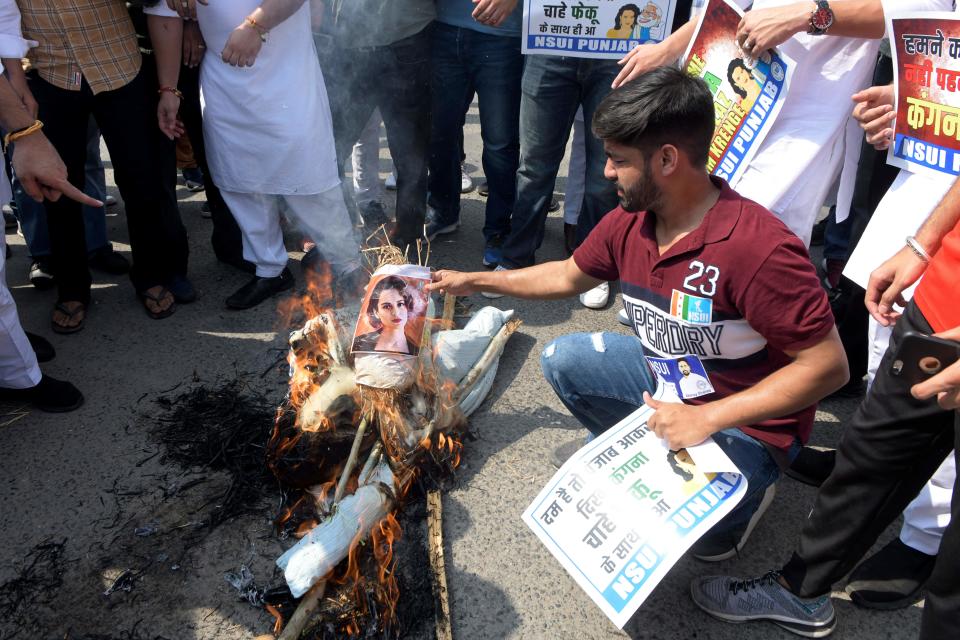 NSUI activists burn an effigy of Kangana Ranaut after her tweet regarding the agri-marketing Bills. (Photo by NARINDER NANU/AFP via Getty Images)