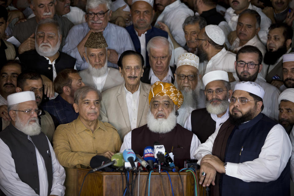 Maulana Fazlur Rehman, center, head of Pakistani religious parties alliance talks to media with other Pakistani politicians after the All Parties Conference (APC) in Islamabad, Pakistan, Friday, July 27, 2018. Rehman told that APC has rejected the results of the July 25 general election result. With Pakistani election officials declaring the party of Imran Khan to be the winner of parliamentary balloting, the former cricket star turned Friday to forming a coalition government, since the party did not get an outright majority.(AP Photo/B.K. Bangash)