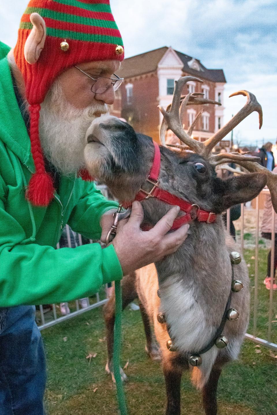 Noel, one of Santa's reindeer-in-training, stops for a quick kiss from his handler elf,  John Schrader. The reindeer came to visit Caldwell and met children on the courthouse lawn as Santa heard Christmas wishes. The reindeer are managed by the Jungle Island Zoo company out of Delphos, Ohio.