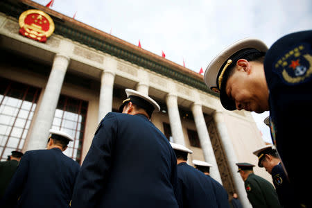 FILE PHOTO: Military delegates arrive for the opening session of the National People's Congress (NPC) at the Great Hall of the People in Beijing, China March 5, 2018. REUTERS/Thomas Peter/File Photo