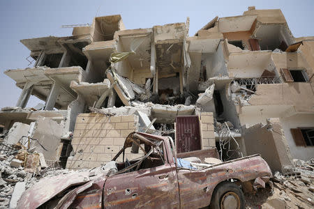A damaged building is seen in Raqqa city. REUTERS/ Rodi Said