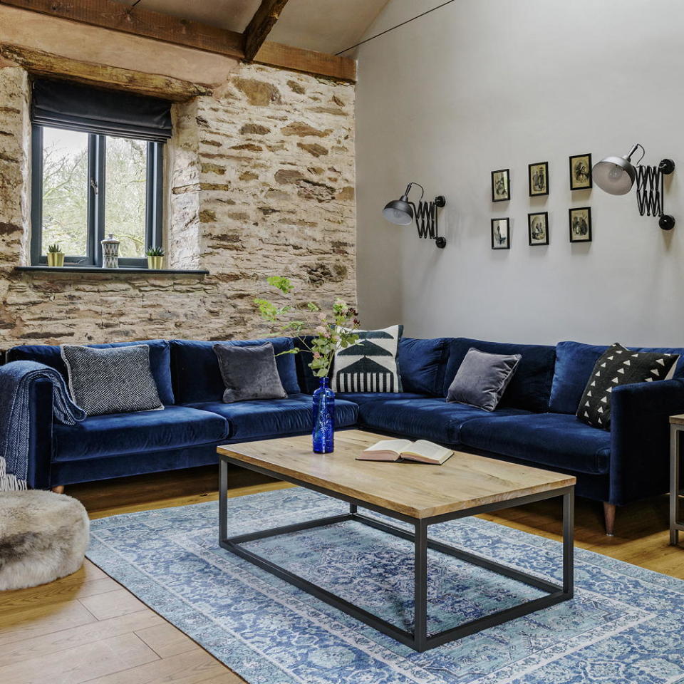 Contrast an exposed stone wall with midnight blue