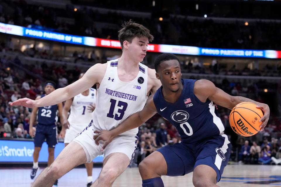 Penn State's Kanye Clary retreats as Northwestern's Brooks Barnhizer defends during the first half of an NCAA college basketball game at the Big Ten men's tournament, Friday, March 10, 2023, in Chicago. (AP Photo/Charles Rex Arbogast)