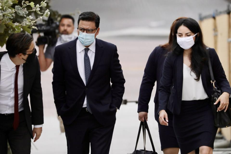 Jose Huizar, center, arrives at the federal courthouse in downtown Los Angeles.