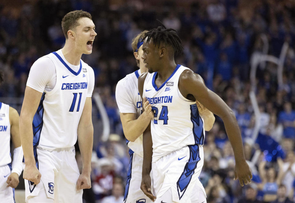 From left to right, Creighton's Ryan Kalkbrenner, Baylor Scheierman and Arthur Kaluma celebrate after Kaluma's basket against Providence during the second half of an NCAA college basketball game Saturday, Jan. 14, 2023, in Omaha, Neb. (AP Photo/Rebecca S. Gratz)