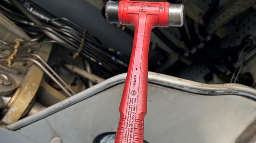 A hammer is seen being held by an American Airlines pilot after, the carrier's pilots union says, it was discovered in an Airbus A319 on March 25 at Phoenix Sky Harbor Airport before the flight left for Cedar Rapids, Iowa. / Credit: Allied Pilots Association via CBS News