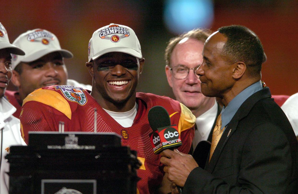 USC running back Reggie Bush is interviewed by ABC broadcaster Lynn Swann after the Trojans' 55-19 win over Oklahoma in the BCS national championship game on Jan. 4, 2005 at the Orange Bowl. Bush won the Heisman Trophy the following season.