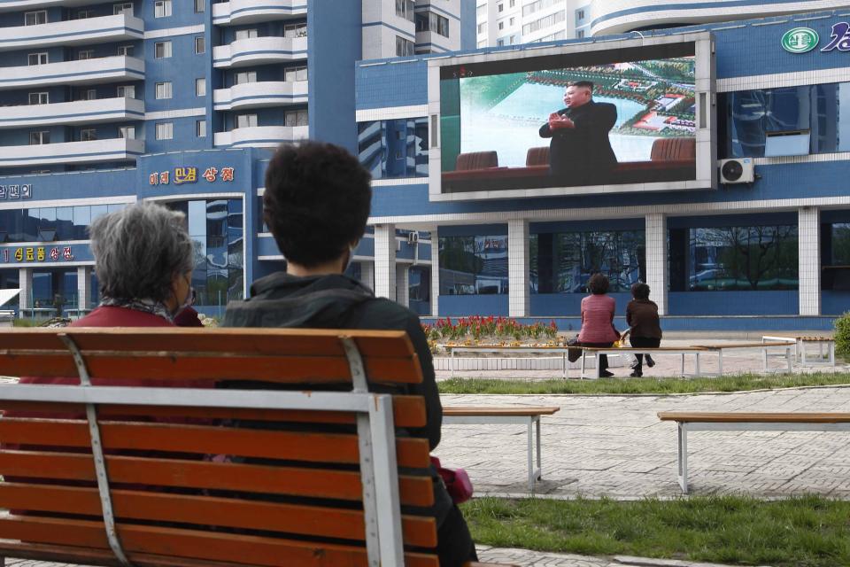 People in a park watch news broadcasted on a giant screen showing leader Kim Jong Un attending the opening ceremony of the Sunchon Phosphatic Fertilizer Factory Saturday, May, 2nd. 2020, in Pyongyang, North Korea. Un made his first public appearance in 20 days as he celebrated the completion of a fertilizer factory near Pyongyang, state media said Saturday, ending an absence that had triggered global rumors that he may be seriously ill. (AP Photo/Jon Chol Jin)