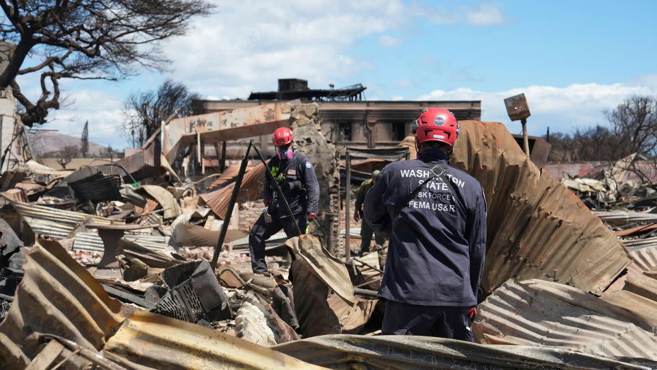 Members of FEMA urban search and rescue teams go through destroyed neighborhoods in Lahaina, Hawaii, on Sunday. - Dominick Del Vecchio/Reuters