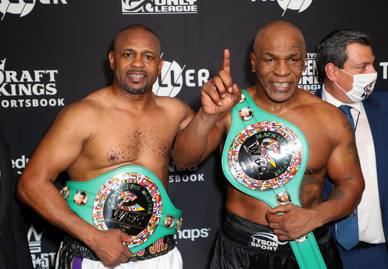 LOS ANGELES, CALIFORNIA - NOVEMBER 28: Roy Jones Jr. (L) and Mike Tyson celebrate their split draw during Mike Tyson vs Roy Jones Jr. presented by Triller at Staples Center on November 28, 2020 in Los Angeles, California. (Photo by Joe Scarnici/Getty Images for Triller)