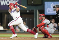 Texas Rangers' Josh Jung (6) follows through on his single in front of St. Louis Cardinals catcher Willson Contreras (40) during the third inning of a baseball game, Wednesday, June 7, 2023, in Arlington, Texas. (AP Photo/Jim Cowsert)