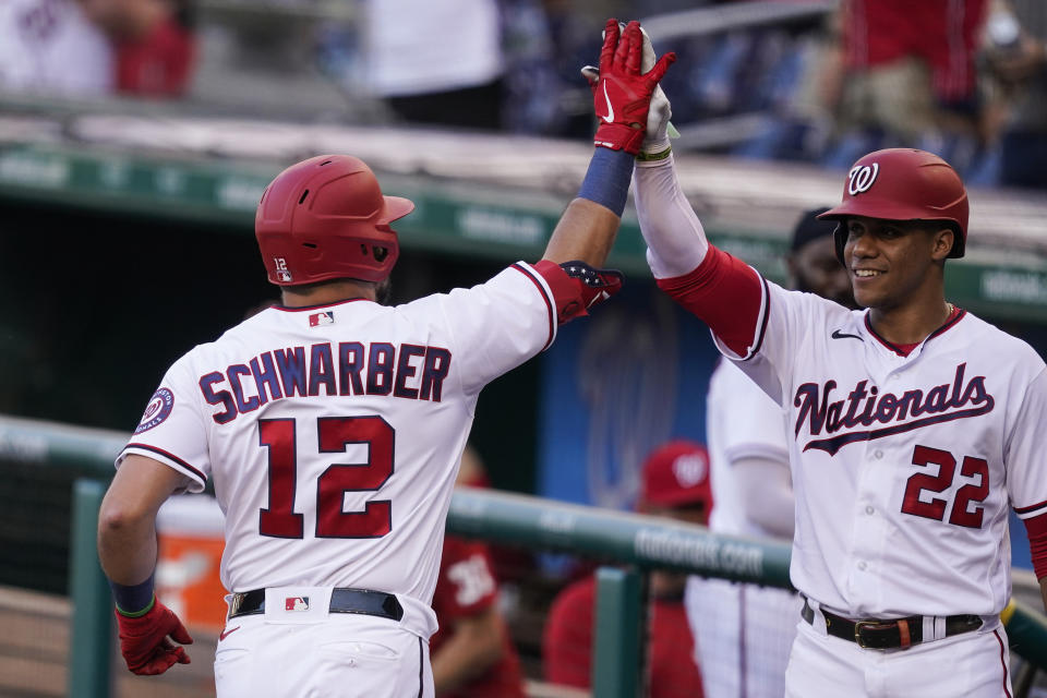 Washington Nationals' Kyle Schwarber celebrates his solo home run with Juan Soto during the first inning of a baseball game against the Tampa Bay Rays, at Nationals Park, Tuesday, June 29, 2021, in Washington. (AP Photo/Alex Brandon)