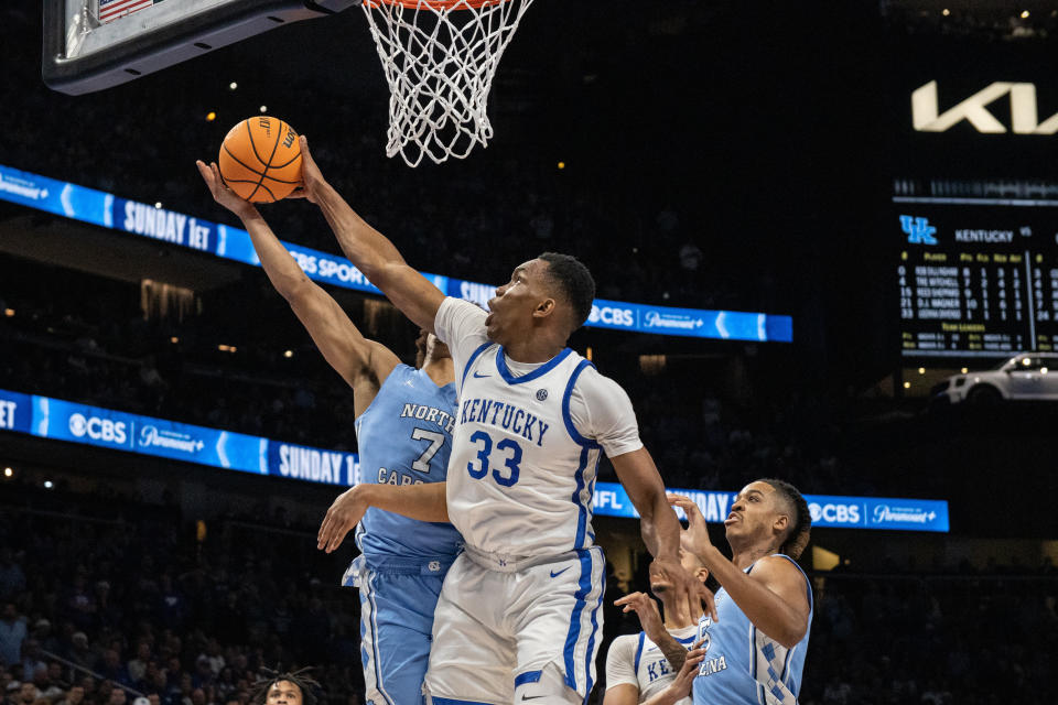 Dec 16, 2023; Atlanta, Georgia, USA; Kentucky Wildcats forward Ugonna Onyenso (33) blocks the shot by North Carolina Tar Heels guard Seth Trimble (7) during the second half at State Farm Arena. Mandatory Credit: Jordan Godfree-USA TODAY Sports