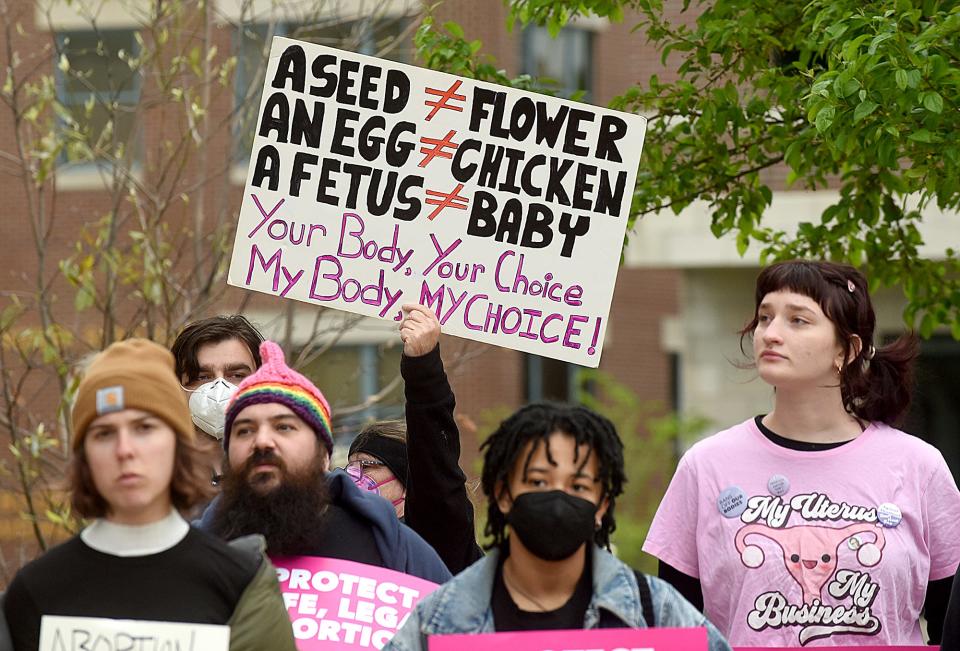 A woman on Tuesday holds a sign opposing the Supreme Court’s leaked draft opinion that would strike down the landmark Roe v. Wade decision giving women a legal right to an abortion while attending a protest at the Boone County Courthouse.