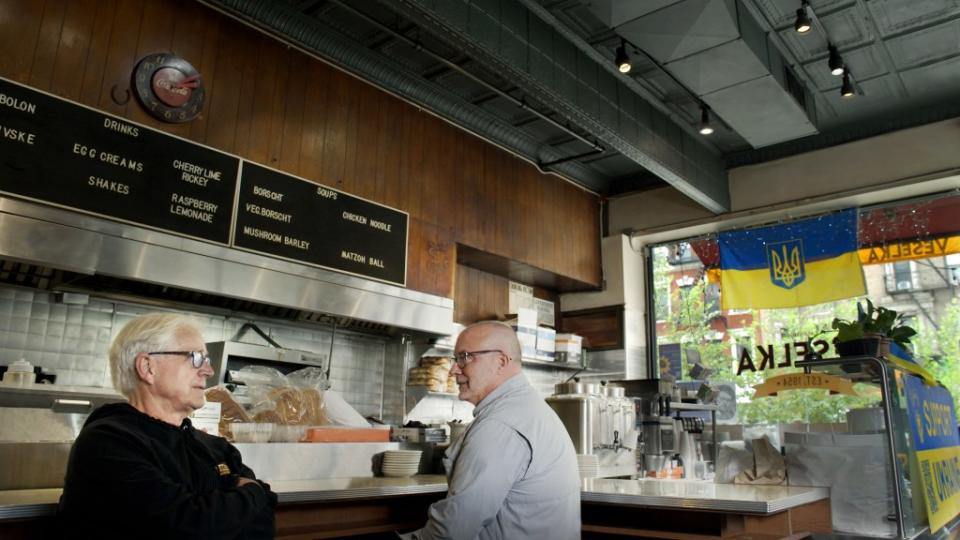 Tom Birchard and son Jason, the owner of Veselka, sit at their restaurant’s counter.