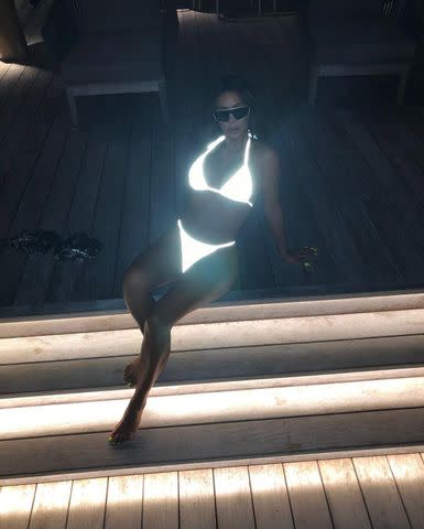 <p>kimkardashian/Instagram</p> Kim Kardashian poses in a glowing white bikini in a new Instagram photo