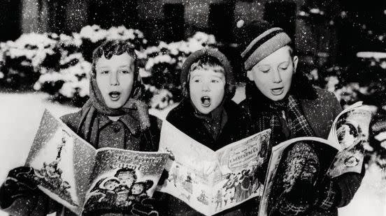 black and white picture of children singing christmas carols