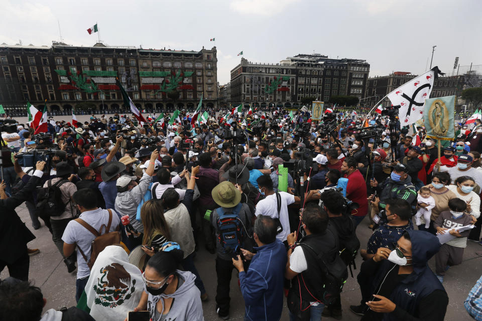 Police in riot gear block demonstrators who are demanding the resignation of Mexican President Andrés Manuel López Obrador, commonly known by his initials AMLO, from entering Mexico City's main square the Zocalo, Wednesday, Sept. 23, 2020. (AP Photo/Marco Ugarte)