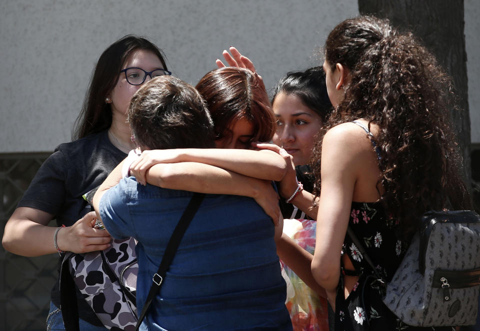 Relatives of passengers of a missing military plane comfort each other as they arrive at the Cerrillos airbase in Santiago, Chile, Tuesday, Dec. 10, 2019. Chile's air force said it lost radio contact with a C-130 Hercules transport plane carrying 38 people on a flight to the country's base in Antarctica, and authorities are indicating they are not optimistic about the aircraft's fate. (AP Photo/Luis Hidalgo)