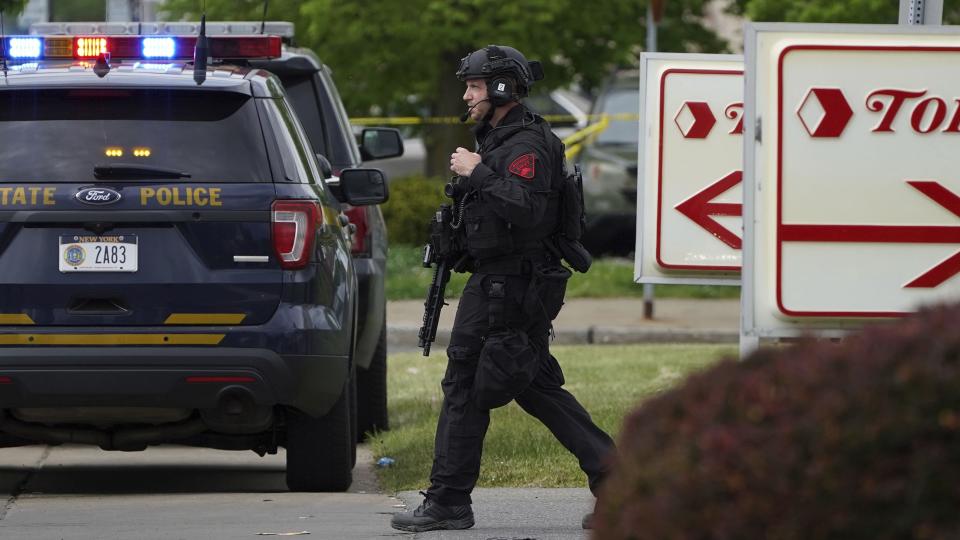 Police secure the area around a supermarket where several people were killed in a shooting, Saturday, May 14, 2022 in Buffalo, N.Y. Officials said the gunman entered the supermarket with a rifle and opened fire. Investigators believe the man may have been livestreaming the shooting and were looking into whether he had posted a manifesto online.