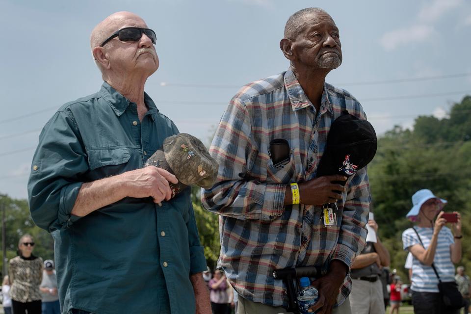 Longtime friends and former coworkers, Butch Medford, left, and Thomas Bryant, hold their hats as they listen to the final shift whistle across from Evergreen Packaging May 24, 2023. “It’s a sad day,” said Bryant, who worked at the mill for 33 years, where Medford also worked for 24 years.