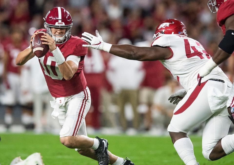 Alabama quarterback <a class="link " href="https://sports.yahoo.com/nfl/players/33403" data-i13n="sec:content-canvas;subsec:anchor_text;elm:context_link" data-ylk="slk:Mac Jones;sec:content-canvas;subsec:anchor_text;elm:context_link;itc:0">Mac Jones</a> (10) eludes Arkansas defensive lineman <a class="link " href="https://sports.yahoo.com/nfl/players/33595" data-i13n="sec:content-canvas;subsec:anchor_text;elm:context_link" data-ylk="slk:Jonathan Marshall;sec:content-canvas;subsec:anchor_text;elm:context_link;itc:0">Jonathan Marshall</a> (42) at Bryant-Denny Stadium in Tuscaloosa, Ala., on Saturday October 26, 2019.