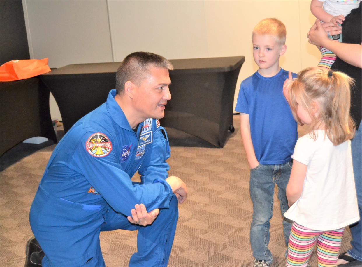 Astronaut Kjell Lindgren speaks to Forrest Harmon, 6, and Norah Harmon, 4, following a presentation about his time in space Thursday, April 13, 2023, at the Fort Collins Museum of Discovery in Fort Collins, Colo. Forrest and Norah are home-schooled and attended the presentation with their mother, Karalee and younger sister, Charlotte, 2.