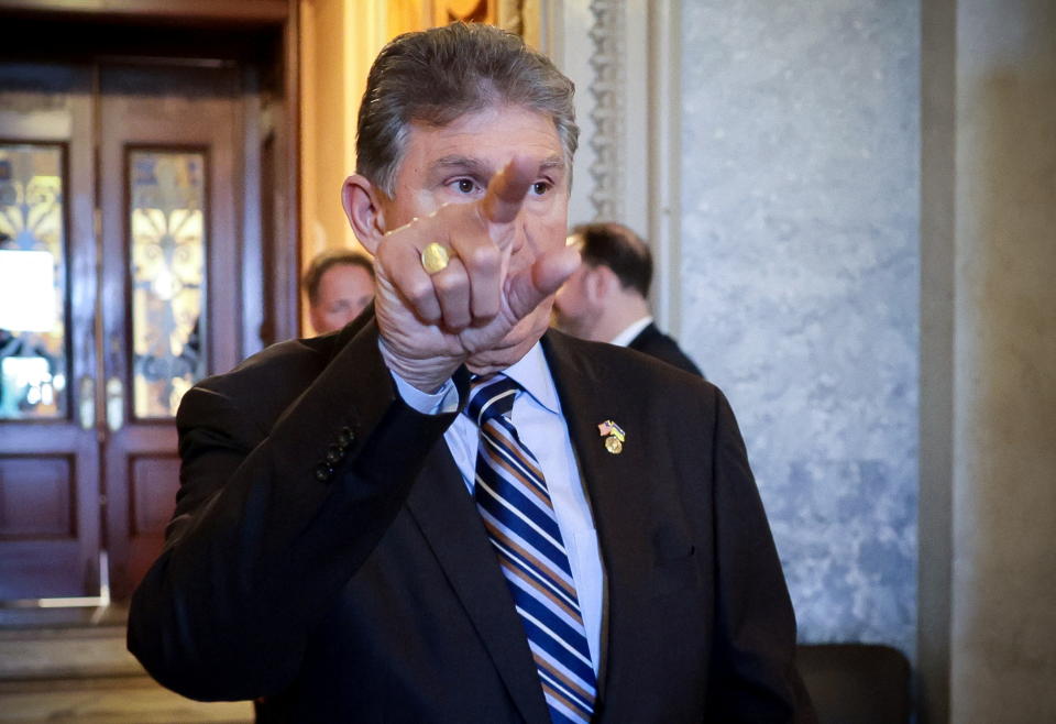 Senator Joe Manchin (D-WV) points towards an exit at the United States Capitol building in Washington, U.S., May 26, 2022. REUTERS/Evelyn Hockstein
