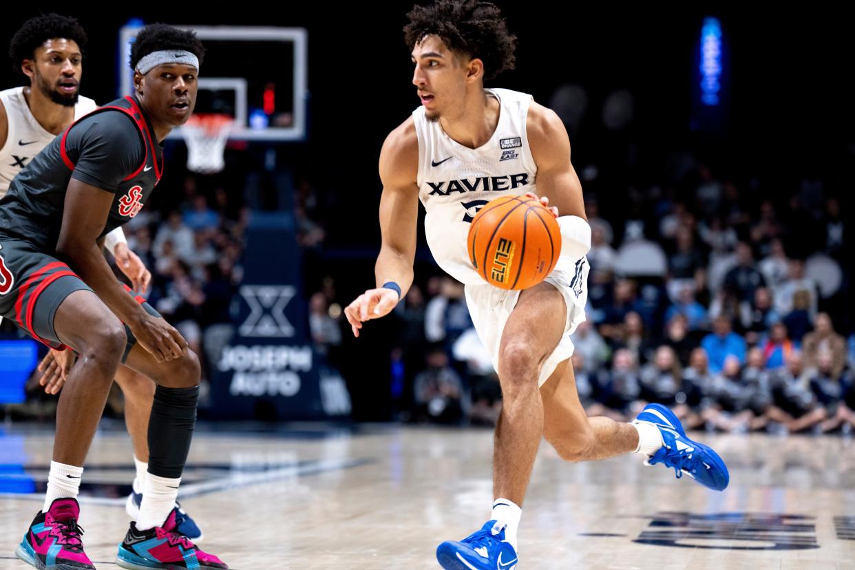 Xavier Musketeers guard Colby Jones (3) dribbles down court in the second half of the NCAA men’s basketball game between the Xavier Musketeers and the St. John's Red Storm at the Cintas Center in Cincinnati on Saturday, Feb. 4, 2023. 