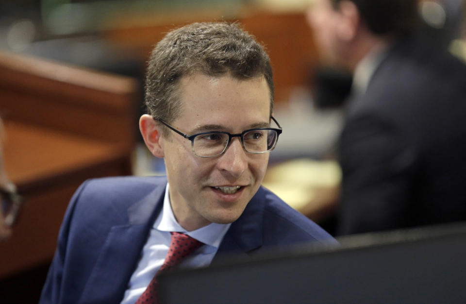 Attorney R. Stanton Jones, counsel for Common Cause, speaks with a colleague as a three-judge panel of the Wake County Superior Court presides over the trial of Common Cause, et al v. Lewis, et al at the Campbell University School of Law in Raleigh, N.C., Monday, July 15, 2019. (AP Photo/Gerry Broome)