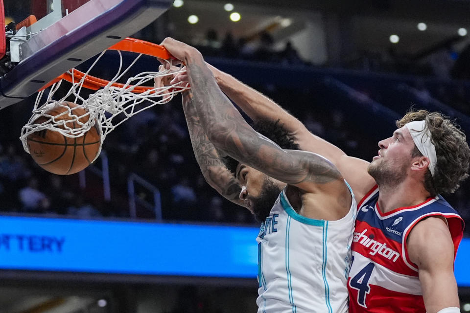 Charlotte Hornets center Nick Richards dunks in front of Washington Wizards forward Corey Kispert, right, during the first half of an NBA basketball game Friday, March 8, 2024, in Washington. (AP Photo/Alex Brandon)