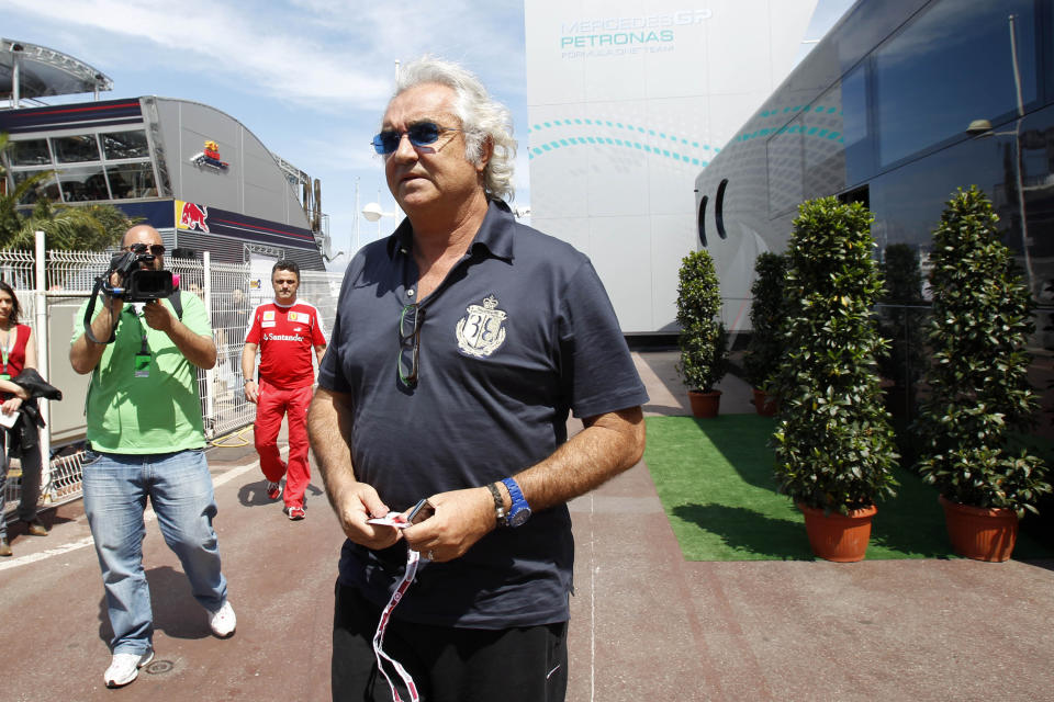 FILE - In this May 14, 2010 file photo, former Renault Team Principal Flavio Briatore leaves the FIA motorhome ahead of the Monaco Formula One Grand Prix at the Monaco racetrack, in Monaco. On Tuesday Aug. 25, 2020, Briatore has reportedly been admitted to hospital in Milan with coronavirus, there has been no official statement from the hospital but multiple reports say Briatore’s condition is serious but he is not in intensive care. (AP Photo/Luca Bruno, file)