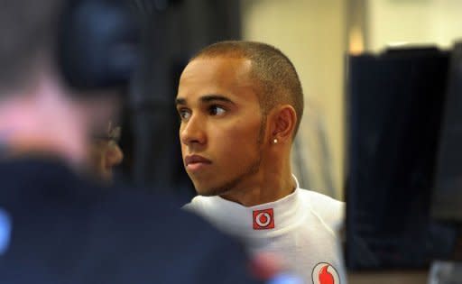 British McLaren-Mercedes driver Lewis Hamilton checks his car during the first practice session of the Formula One Singapore Grand Prix. Hamilton was quickest in an incident-packed opening session -- delayed because of problems with kerbing and then punctuated by red flagged interruptions for various minor incidents