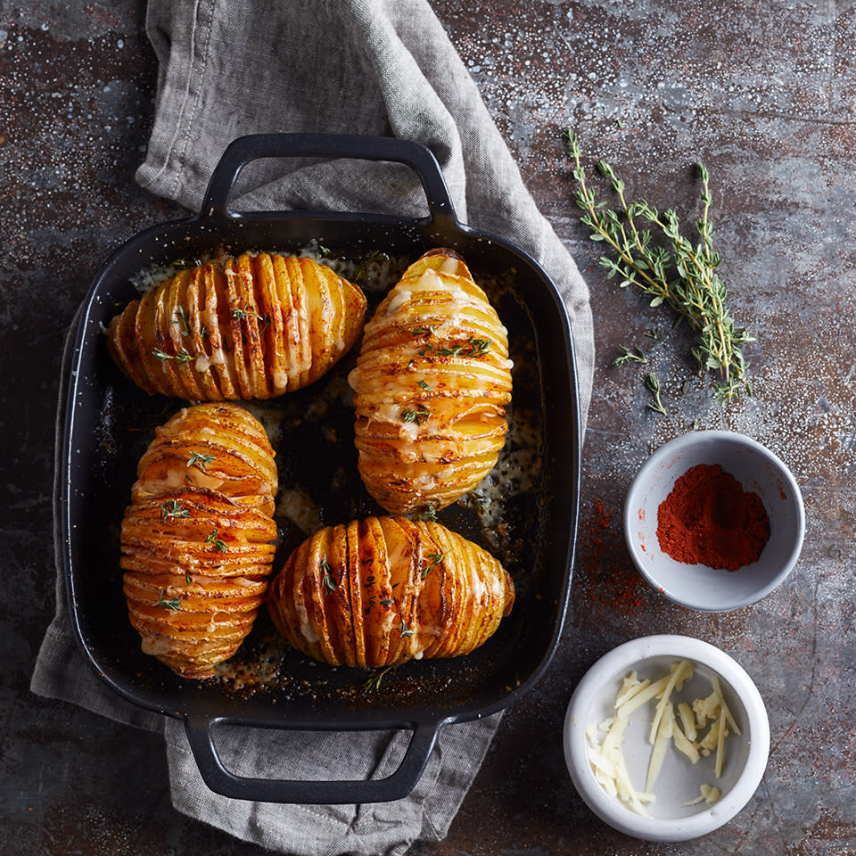 <p>Hasselback potatoes are the perfect side dish for people who love crispy potato-chip-like slices as well as the tender interior of a baked potato. Simple to prepare, these hasselback potatoes look impressive and decadent with melted Cheddar cheese and a sprinkle of paprika on top. <a href="https://www.eatingwell.com/recipe/260745/hasselback-potatoes-with-cheese/" rel="nofollow noopener" target="_blank" data-ylk="slk:View Recipe;elm:context_link;itc:0;sec:content-canvas" class="link ">View Recipe</a></p>