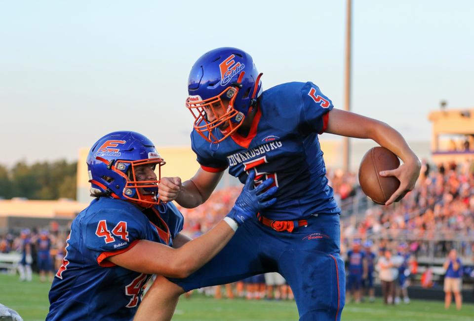 Brendan Madison (5) of Edwardsburg celebrates with teammate Sam Slocum (44) after scoring a touchdown during Friday night’s game against Niles at Edwardsburg.