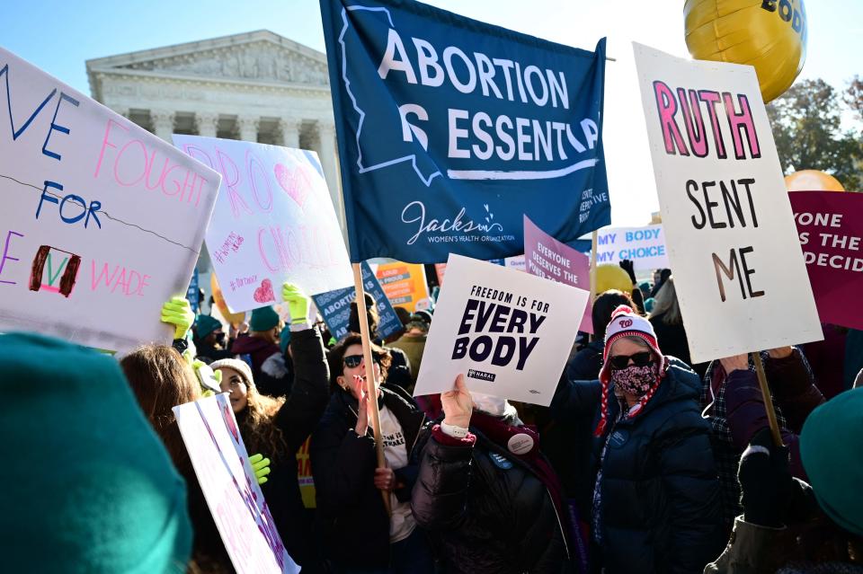 Activists from both sides demonstrate in front of the Supreme Court in Washington on Dec. 1 as justices heard arguments on whether to uphold a Mississippi law that bans abortion after 15 weeks.