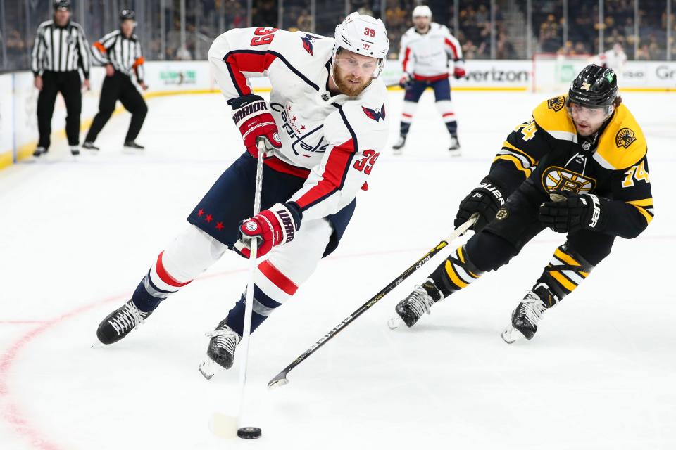 Capitals forward Anthony Mantha skates with the puck against the Bruins' Jake DeBrusk in Game 4 of the first round of the Stanley Cup playoffs on Friday, May 21, 2021, in Boston.