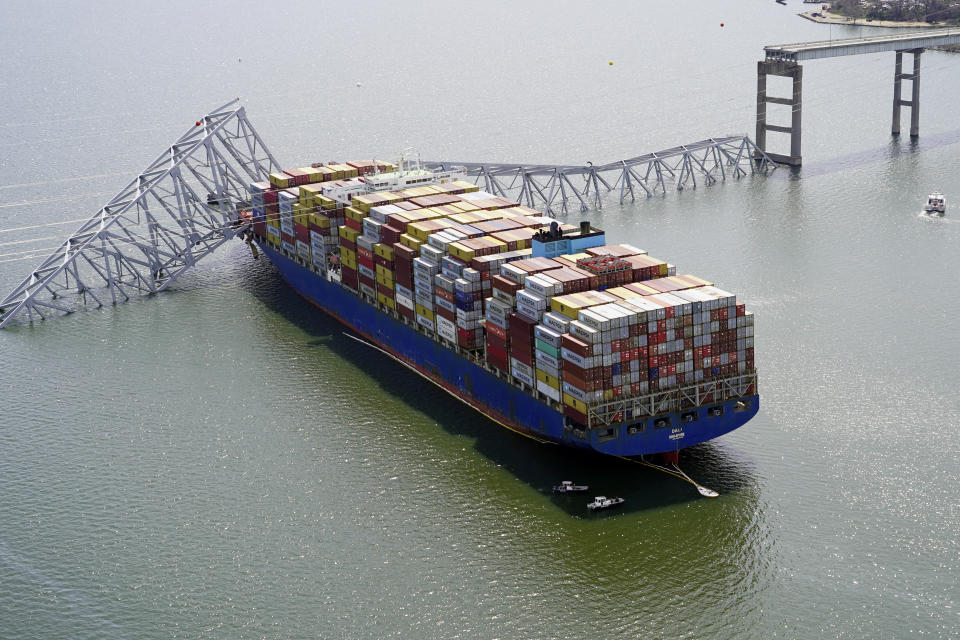 In this aerial image released by the Maryland National Guard, the cargo ship Dali is stuck under part of the structure of the Francis Scott Key Bridge after the ship hit the bridge, Tuesday, March 26, 2024, in Baltimore. (Maryland National Guard via AP)