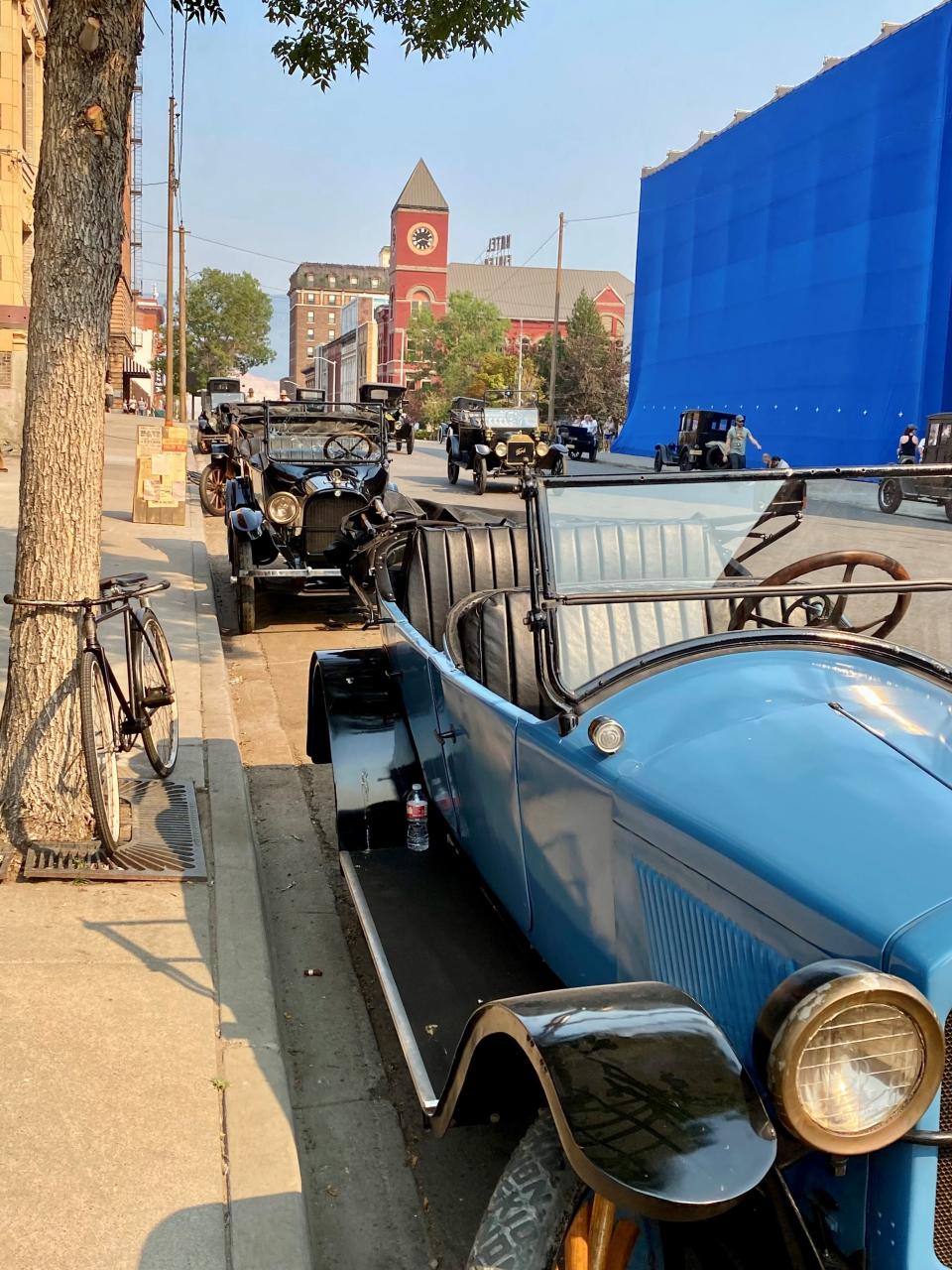 Old meets new on the Butte, Montana set of "1923" where Palm Beach resident Carey O'Donnell spent days working as an extra. The cars are vintage, but the building was not, so it was draped in blue to be digitally replaced.