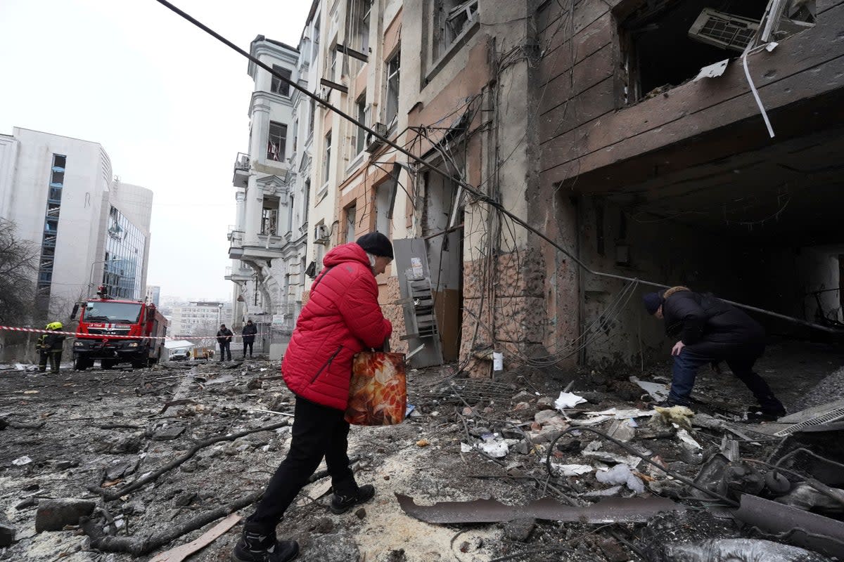 Owners of apartments enter a residential building which was hit by a Russian rocket at the city center of Kharkiv on Sunday (AP Photo/Andrii Marienko)