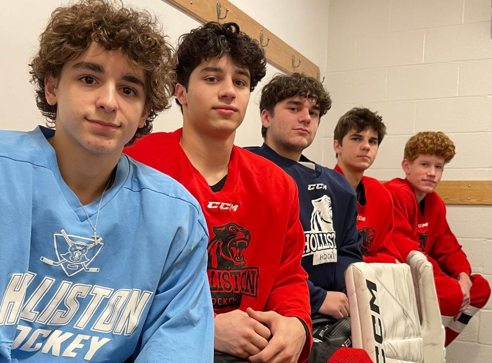 Holliston's captains, from left, Cole Fanara, James Givens, Evan Kuharich (alternate) and John Piselli flank goalie Caleb Greenberg (middle) before practice at Loring Arena in Framingham on Feb. 2, 2024.