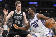 Sacramento Kings' Harrison Barnes (40) drives against San Antonio Spurs' Jakob Poeltl during the first half of an NBA basketball game, Sunday, Jan. 15, 2023, in San Antonio. (AP Photo/Darren Abate)