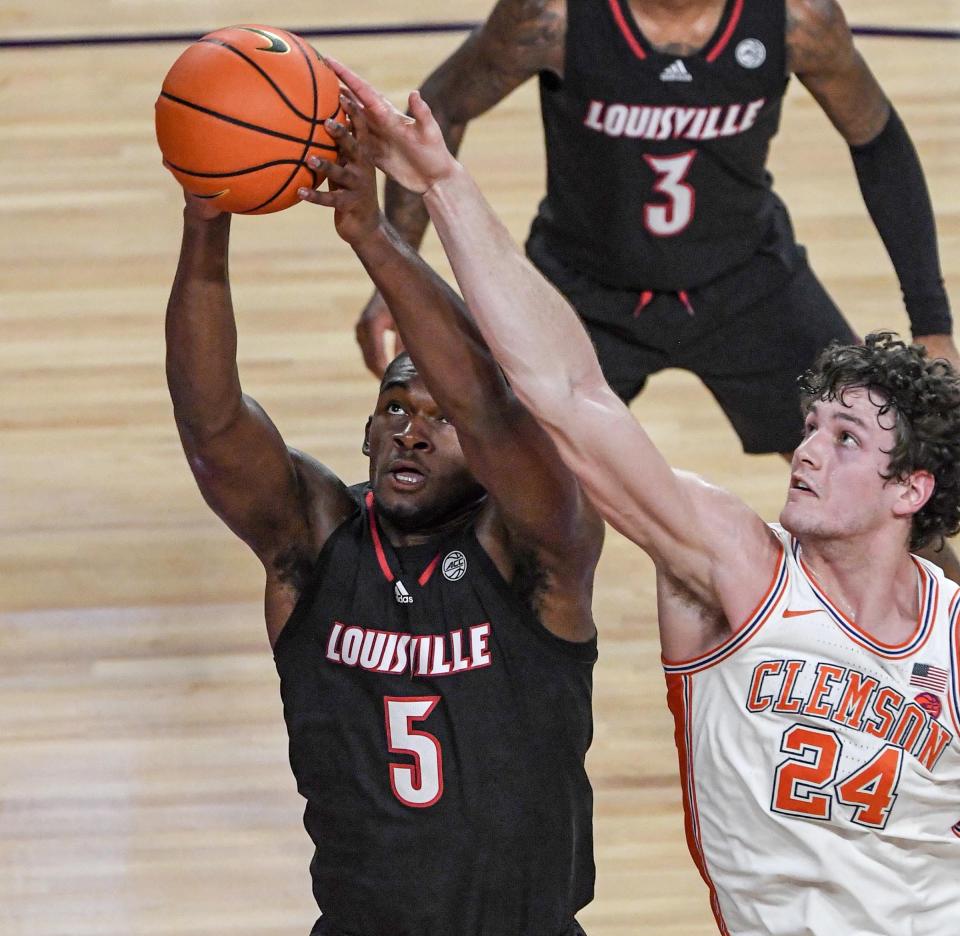 Jan 11, 2023; Clemson, South Carolina, USA; Louisville Cardinals forward Brandon Huntley-Hatfield (5) rebounds near Clemson Tigers forward PJ Hall (24) during the first half at Littlejohn Coliseum. Mandatory Credit: Ken Ruinard-USA TODAY Sports