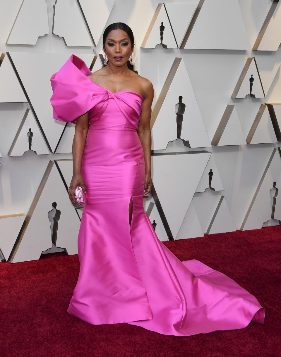 <p>The “Black Panther” star was right on trend in a pink Reem Acra gown with one shoulder detail. <em>[Photo: Getty]</em> </p>
