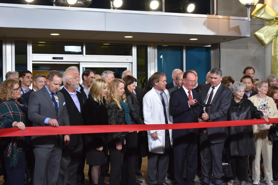 Community Memorial leaders cut the ribbon on a new hospital in 2018. CEO Gary Wilde is third from the right in the front row.