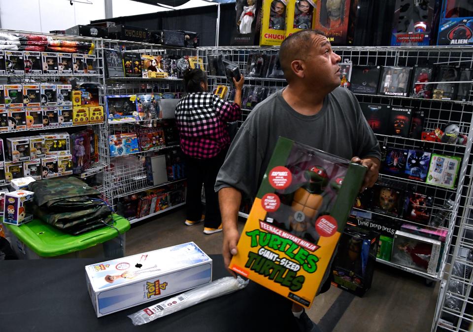 Ed Trevino sets up the Leonor Collectibles vendor space with his sister Francis Hernandez Friday at the Abilene Convention Center. The family came from Pasadena, near Houston, for Abilene Comic Con