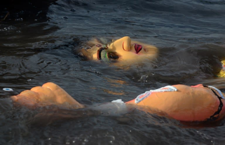 <p>A clay idol of goddess Durga floats after being immersed by Hindu devotees in the Mahananda river in Siliguri on October 11, 2016, at the end of the Durga Puja festival. Durga Puja commemorates the slaying of demon king Mahishasur by goddess Durga, marking the triumph of good over evil. </p>