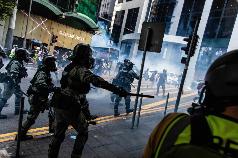 HONG KONG, CHINA - 2019/11/11: Riot police officers march towards protesters during the demonstration. Entering the 5th month of civil unrest, protesters blocked roads and trains, pushing for a general strike. Earlier in the day, a protester was shot by a live round as they chanted slogans and continued to ask for the five demands to be met. Protesters clashed with riot police and were hit with tear gas and rubber bullets until several were eventually arrested. (Photo by Willie Siau/SOPA Images/LightRocket via Getty Images)